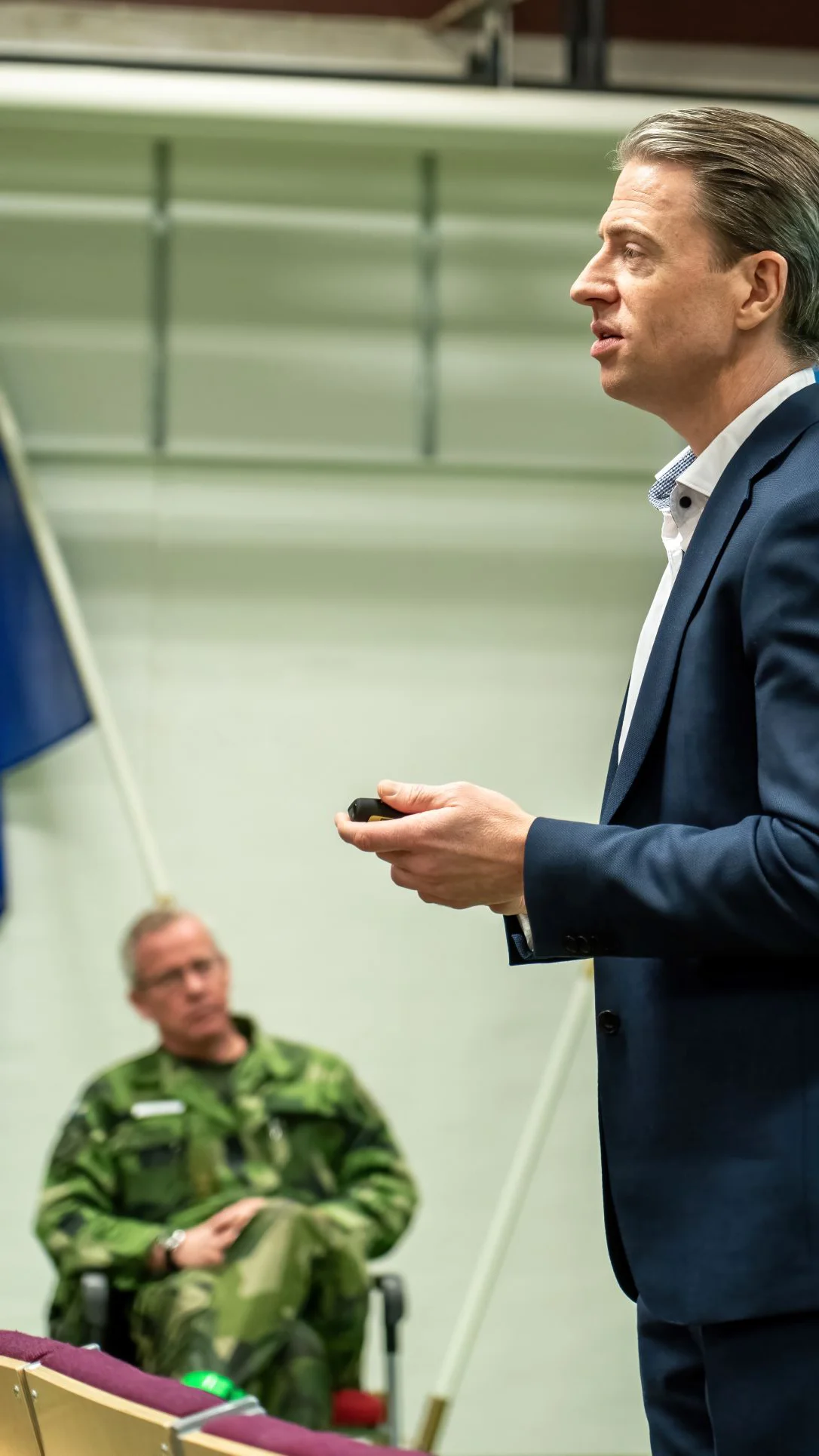 Chris Monö - speaking with military man in the background